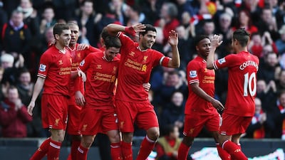 Liverpool’s Luis Suarez, centre, hopes he can translate his scoring frenzy into a title. Clive Brunskill / Getty Images