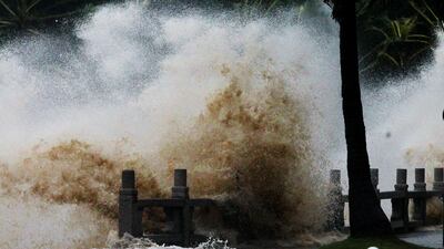 A wave caused by Typhoon Hato surges past the barrier along the seacoast in Zhuhai in China's southern Guangzhou province. AFP.