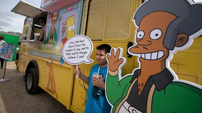 Migael Pimentel, 9, holds up an Apu saying as he has his photo taken at the Simpsons Kwik-E-Mart Truck at South Bites Food during SXSW at the Austin Convention Center in Austin, Texas. AP