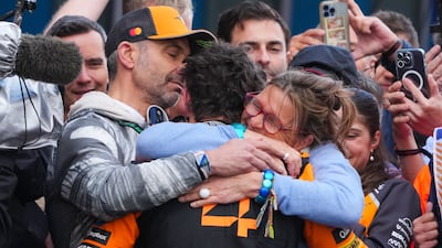 McLaren driver Lando Norris of Britain is congratulated by his father Adam and mother Cisca after winning the Australian GP. AP
