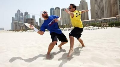 Dubai Ultimate Players Association Frisbee team members Patrick Fourcampre-Maye, left and Matthieu Roshay practise their skills at Jumeirah Beach Residences.