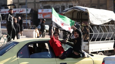 Residents celebrate as government armed forces enter Raqqa city following the withdrawal of the SDF and announcement of a ceasefire on Sunday. Getty Images