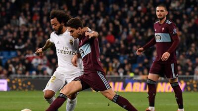 Real Madrid's Brazilian defender Marcelo challenges Celta Vigo's Spanish midfielder Denis Suarez. AFP