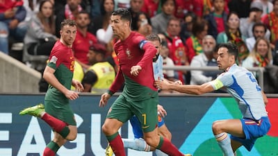 Cristiano Ronaldo on the ball under pressure from Spain midfielder Sergio Busquets. EPA