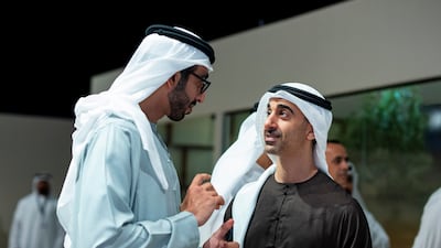 Sheikh Shakhbout bin Nahyan, Minister of State, left, speaks to Sheikh Hamdan bin Mohamed, Deputy Chairman of the Presidential Court for Special Affairs