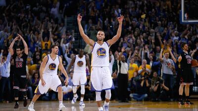Stephen Curry (30) and Klay Thompson celebrate after Harrison Barnes (40) made a three-point basket for Golden State Warriors late in the fourth quarter of their game against the Chicago Bulls. Ezra Shaw / Getty Images