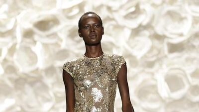 A king of bejewelled red carpet dressing, Naeem Khan mixed his signature sparkle with gowns of sporty stripes on Tuesday. Khan rolled out the dazzle in silver, gold and a starburst of white in a beaded cocktail dress. There were shiny satins in kelly green and sunny yellow in several styles. For that Hollywood moment when only mega-watt gold will do, Khan provided a fully sequinned, body-skimming gown, flared at the bottom with an open back. Peter Foley / EPA