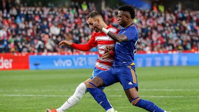Real Madrid's Vinicius Junior, right, fights for the ball with Granada's German. AP Photo