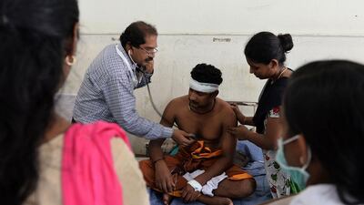 Kollan hospital staff treat a man injured at the Puttingal Devi Temple in Kerala. Manjunath Kiran / AFP Photo