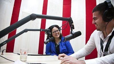 Noof Assi, left, who works for an NGO and presents a late-night radio show, would rather talk about Iraq's future than dwell on the past.