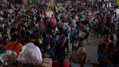 Evacuees from towns affected by the eruption of Taal volcano queue up at an evacuation center in Tanauan town, Batangas province south of Manila. AFP
