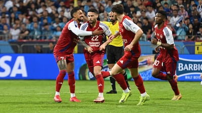 Marcus Meloni, second left, celebrates after his stoppage time winner for Sharjah