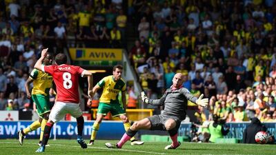 Juan Mata of Manchester United scores his team’s first goal past John Ruddy of Norwich City during the Premier League match between Norwich City and Manchester United at Carrow Road on May 7, 2016 in Norwich, England. (Mike Hewitt/Getty Images)
