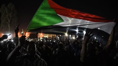 Sudanese protesters waving flags during a sit-in outside military headquarters after clashing with security forces in Khartoum on May 15, 2019. AFP