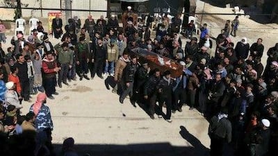 Men carry the coffin of a member of the Free Syrian Army, who was killed by armed civilians loyal to Syria's President Bashar Al Assadin the northern city of Idlib.