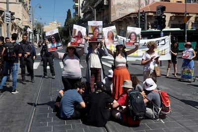 Protesters in Jerusalem block a set of light railway tracks, demanding the release of hostages held in Gaza. Reuters