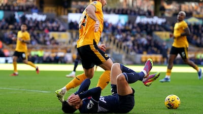 Tottenham Hotspur's Son Heung-Min goes down after a challenge by Wolverhampton Wanderers' Craig Dawson. PA