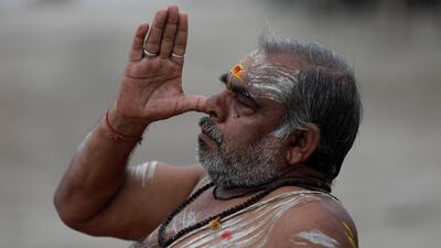 A Hindu holy man performs yoga at Sangam, the confluence of rivers the Ganges and the Yamuna in Prayagraj, India. AP Photo