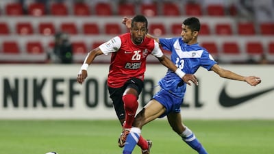 Abdelaziz Haikal, left, avoids getting tackled, but his Al Ahli side were forced to a goalless draw at home to Al Hilal, from Saudi Arabia. Al Ittihad
