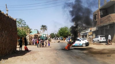 A burning tire blocks the road during an anti-government demonstration in Khartoum's twin city of Omdurman on March 10, 2019. AFP