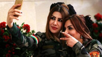 Female peshmegra fighters take a selfie in Arbil, the capital of the Kurdish autonomous region in northern Iraq. Safin Hamed / AFP