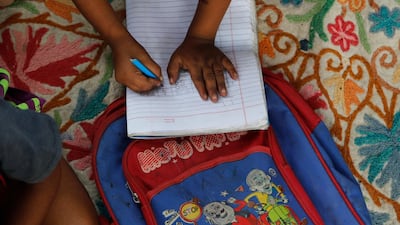 A child practices writing numbers on the pavement in New Delhi, India, on September 3, 2020. Most schools in India have remained shut since late March when the country imposed a nationwide lockdown to curb the spread of Covid-19, but many poorer children lack access to digital devices and internet for online classes. AP