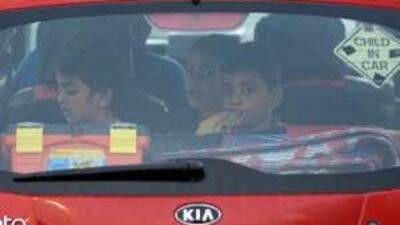 One reader laments the fact that children, who are here seen without seat belts, may still continue to ride in cars without seat belts despite a new law that has been passed.