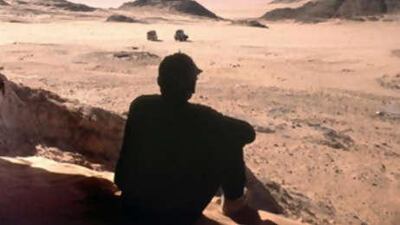 A picture taken on March 28, 2001 shows a tourist taking a break from his tour in Gilf el-Kabir near the Egyptian border with Libya where masked bandits kidnapped a group of foreign tourists.