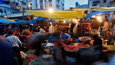Vendors sell vegetables at a wholesale vegetable market in the old quarters of Delhi. A central bank panel has recommended the Reserve Bank of India focus on managing inflation as its main policy objective. Ahmad Masood / Reuters