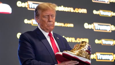 Former president Donald Trump with his gold trainers at Sneaker Con Philadelphia. AP