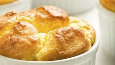 When a soufflé is heated in the oven, the air bubbles swell up, causing the mixture to expand over the top of the dish.
