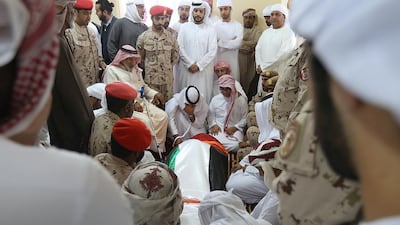 Family members on Thursday with the body of Juma Al Kaabi before funeral prayers in Ras Al Khaimah. The UAE Ambassador to Afghanistan died in a French hospital this week from injuries sustained in a bomb blast in Kandahar in January. Satish Kumar / The National