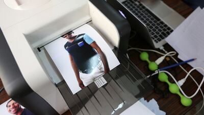 Photo of the laborers printing at the photo booth setup by Gulf Photo Plus Gallery at Al Quoz Industrial Area in Dubai. Pawan Singh / The National