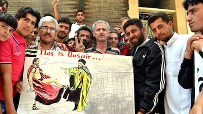 Syrian protesters holding a placard with a caricature of Hizbollah's leader Hassan Nasrallah in Syria's Idlib province on May 31. AP Photo