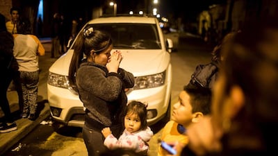 Residents stand on a street outside their homes in Santiago after a 8.3 magnitude earthquake rattles Chile. Pablo Sanhueza / Reuters