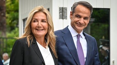 Kyriakos Mitsotakis, right, and his wife Mareva Grabowski-Mitsotakis at the presidential palace on Monday. AFP