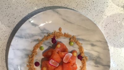 A rosette of cured salmon came served on a marble plate dotted with beetroot puree and dill. Rebecca Duane / The National
