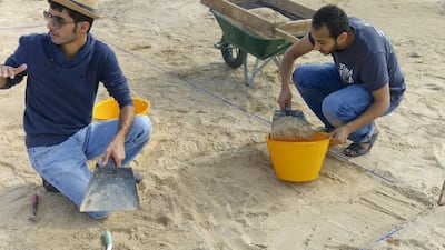 From left: Abdul Al Kaabi, an archaeologist from Abu Dhabi Tourism and Culture Authority (TCA) and Fadhl Al Eryani, an NYUAD student, carry out excavations at Saadiyat site B. TCA, NYUAD and Zayed University are working together on the Saadiyat Coastal Heritage Project. Courtesy Dr Robert Parthesius