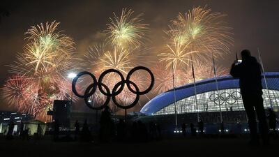 A man takes a photograph of fireworks during the closing ceremony of the 2014 Winter Olympics on February 23, 2014, in Sochi, Russia. AP Photo/Petr David Josek