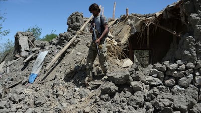 An Afghan soldier patrols near the site of a US bombing during an operation against ISIL militants in the Achin district of Nangarhar province in Afghanistan on April 15. Noorullah Shirzada / AFP