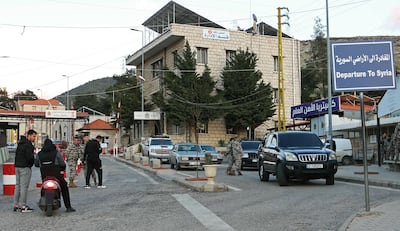 Cars pass through the Lebanon-Syria border crossing in Masnaa. AFP