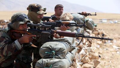 Iraqi Kurdish Peshmerga fighters monitor the area from their front line position in Bashiqa, a town 13 kilometres north-east of Mosul on August 16. Kurdish troops backed by US warplanes launched a bid to recapture Mosul dam, Iraq's largest, from Islamic State militants, a senior Kurdish military official said. Ahmad Al Rubaye / AFP