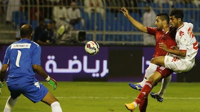 Emirati footballer Ali Mabkhout, centre, and Oman's Mohammed Al Musalami fight for the ball as Oman goalkeeper Ali Al Habasi, left, defends during their Gulf Cup of Nations match at the Prince Faisal bin Fahad Stadium in Riyadh on November 14, 2014. Karim Sahib / AFP