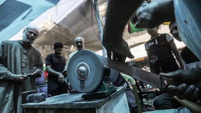 Palestinian blacksmiths sharpen various tools and knives to be used to sacrifice animals in Gaza City. EPA