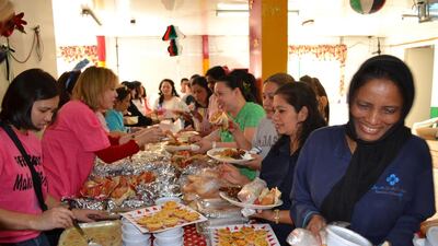 West Coast Ladies Labour Camp workers and women from the Feel Great Helping group enjoy the festive brunch prepared by the charity network for workers unable to be with their families at this time of year. Courtesy Jackie Gasper