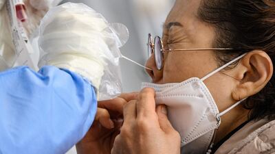 A woman undergoes a PCR test at a Covid-19 testing centre in Seoul, South Korea. AFP