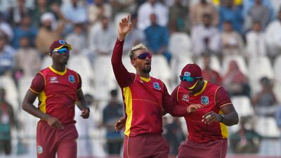 West Indies captain Nicholas Pooran celebrates with teammates after taking the wicket of Mohammad Rizwan. AP