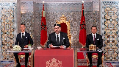 This handout picture provided by the Moroccan Royal Palace on July 29, 2019 shows Morocco's King Mohammed VI (C) delivering a speech marking the 20th anniversary of his accession to the throne,. AFP PHOTO