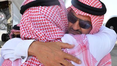 Prince Turki bin Mohammed Al Faisal (R), a relative of the late prince Saud Al Faisal, is comforted as his coffin is unloaded from a plane in Jeddah on July 11, 2015, a few hours before a funeral ceremony held in the Muslim holy city of Mecca. STR/AFP Photo