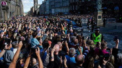 Crowds gather outside St. Giles' Cathedral on the Royal Mile as the queen's coffin passes in Edinburgh. Bloomberg